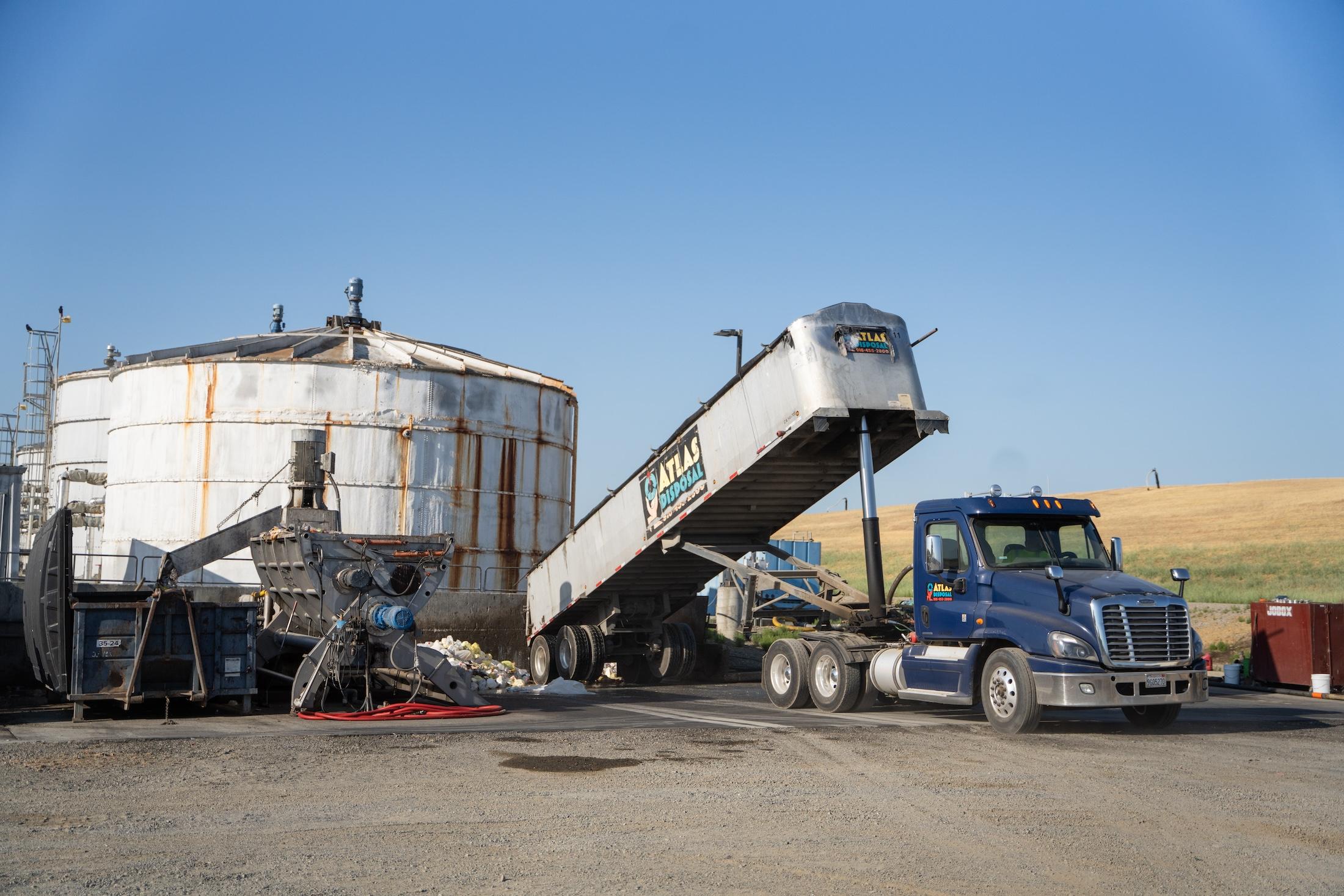 Truck elevates large bed to dump pre-organic waste at the READ facility