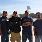 Roofing employees posing for photo.